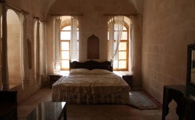 man in black jacket sitting on bed